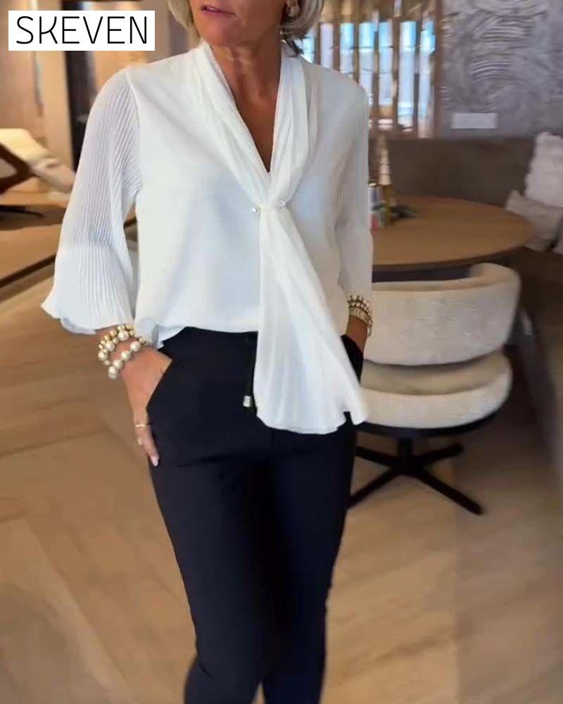 Elegante Bluse mit Glockenärmeln und Schleifen
