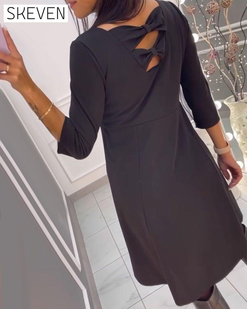 Solid color dress with bow at back