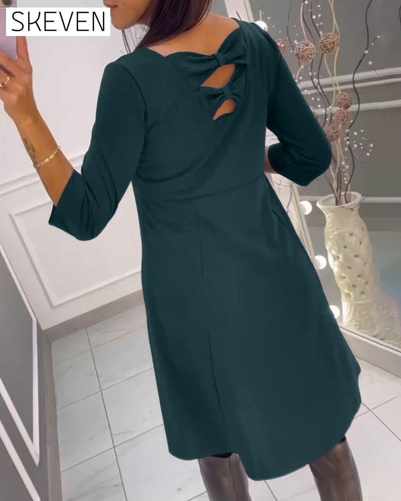 Solid color dress with bow at back