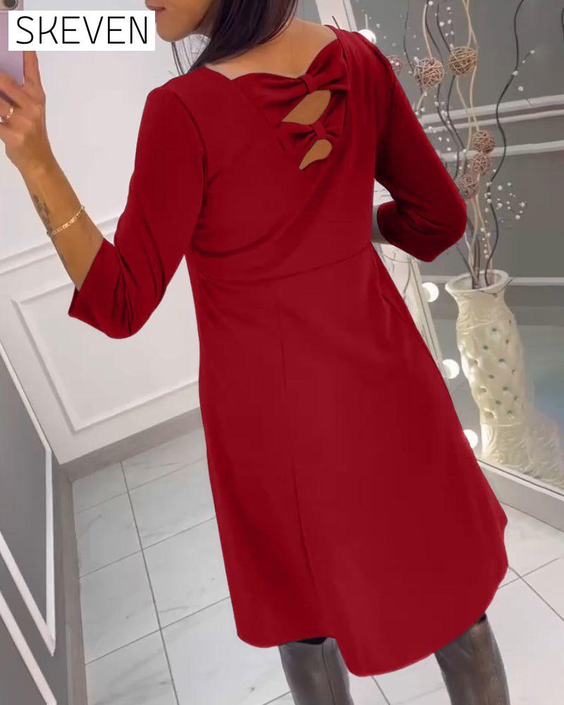 Solid color dress with bow at back
