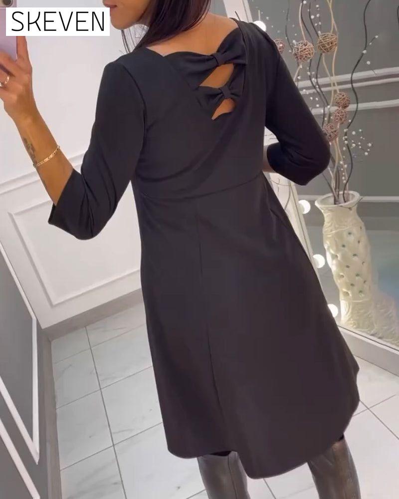 Solid color dress with bow at back