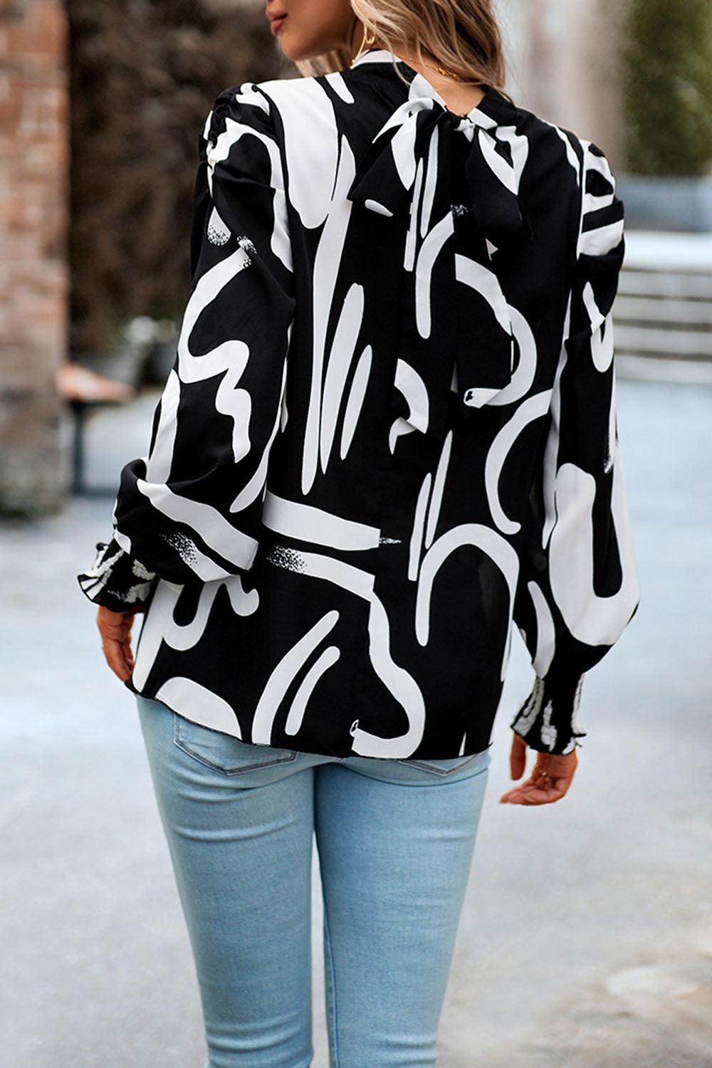 Bedruckte Bluse mit Smokdetails und Puffärmeln