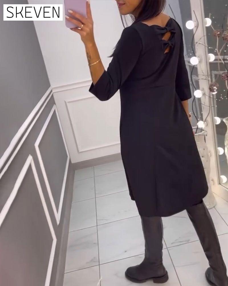 Solid color dress with bow at back