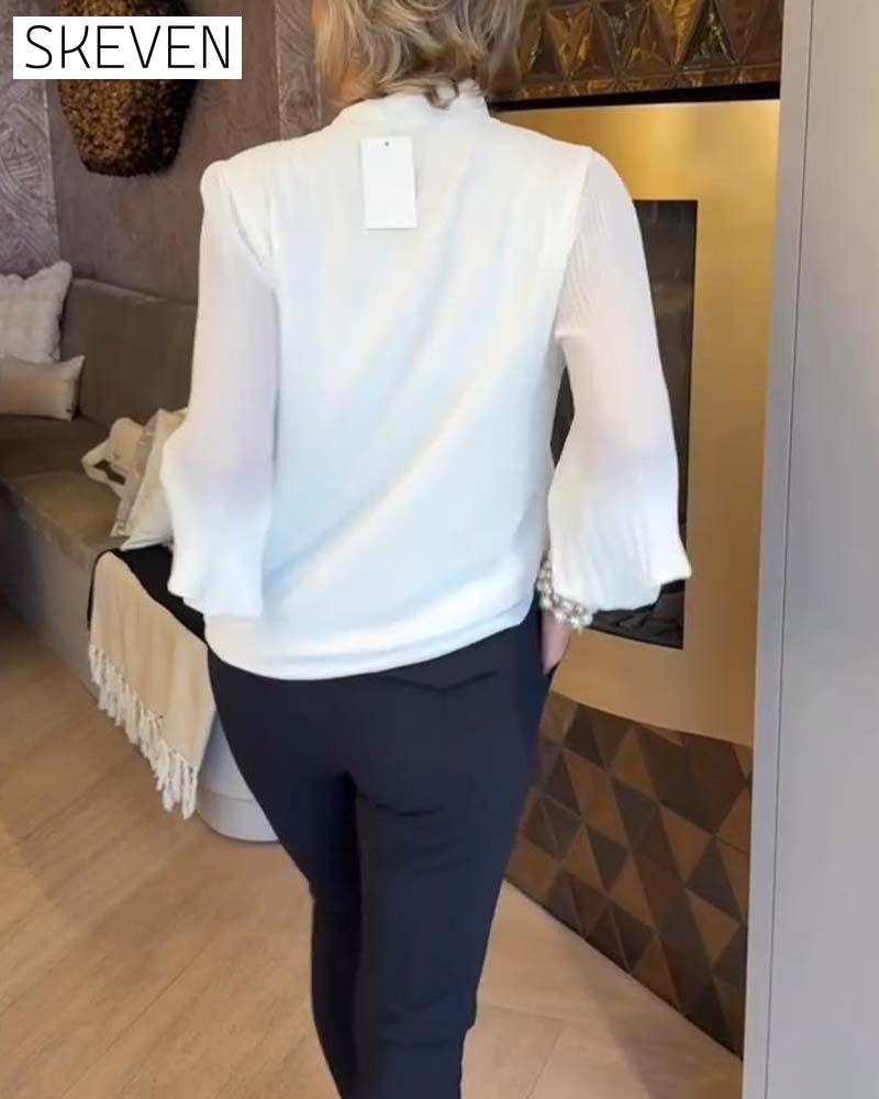 Elegante Bluse mit Glockenärmeln und Schleifen