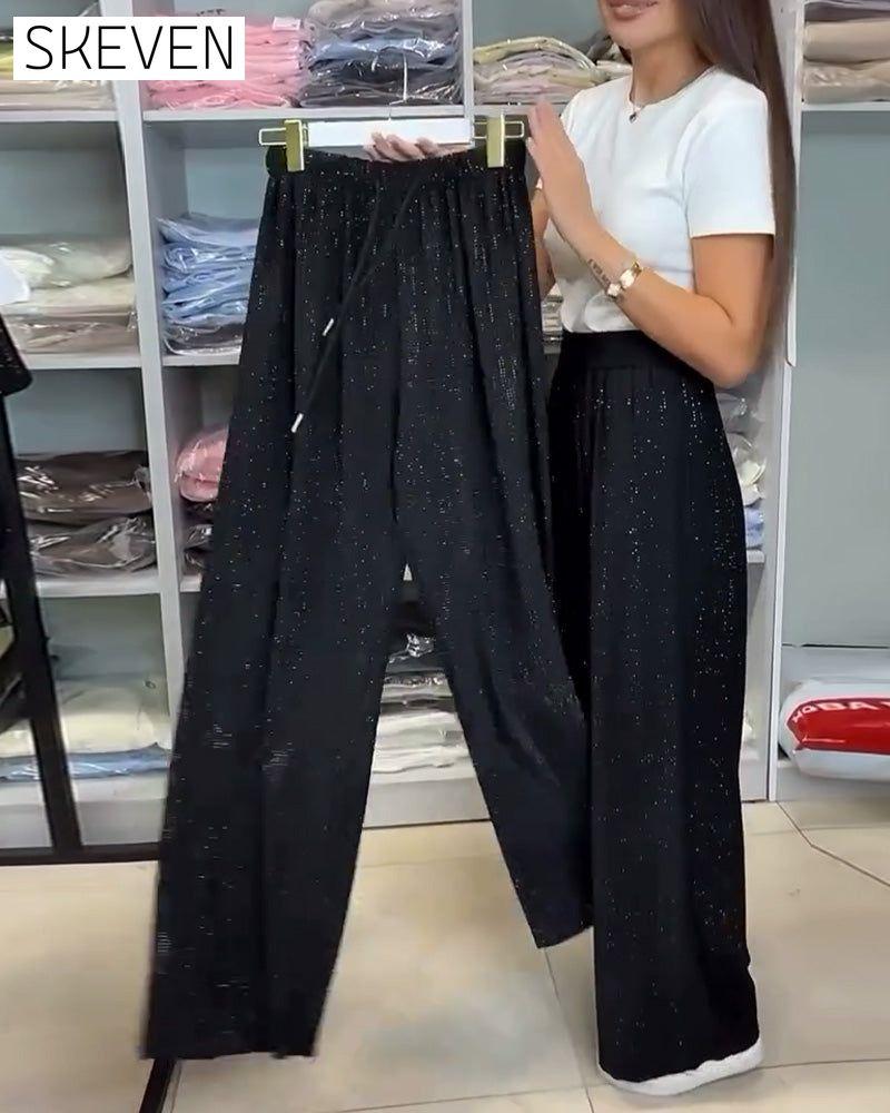 Pantalon élégant à taille haute et jambes larges et brillants