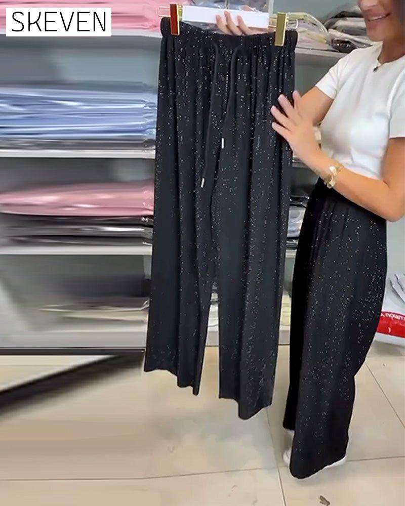 Pantalon élégant à taille haute et jambes larges et brillants