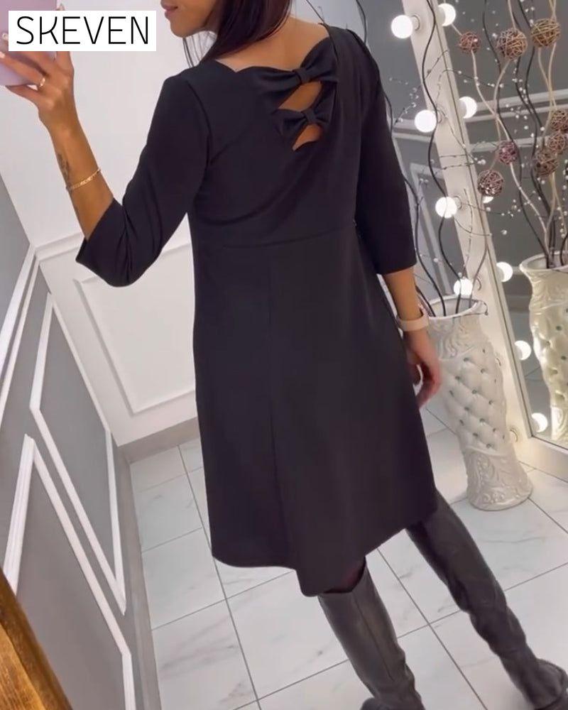 Solid color dress with bow at back